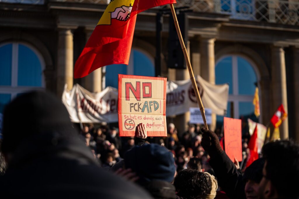 Crowd in Stuttgart demonstrating against AfD with signs and banners.