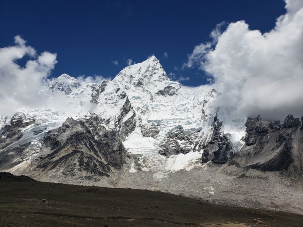 Majestic view of the snow-covered Khumbila mountain under a clear blue sky in Nepal.