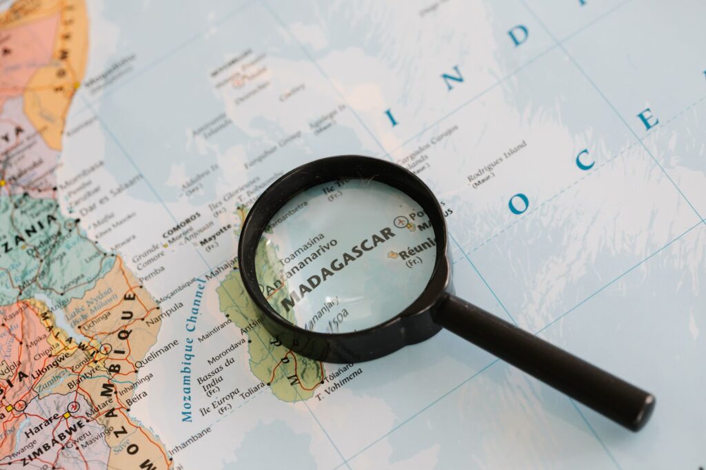 Close-up of Madagascar on a map with a magnifying glass highlighting the area.