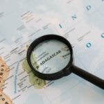 Close-up of Madagascar on a map with a magnifying glass highlighting the area.