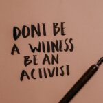 Inspiring handwritten quote with a fountain pen encouraging activism.