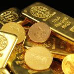 A detailed image of gold bars and coins symbolizing wealth and financial investment.