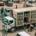 An LPG gas truck making a delivery at a busy urban station.