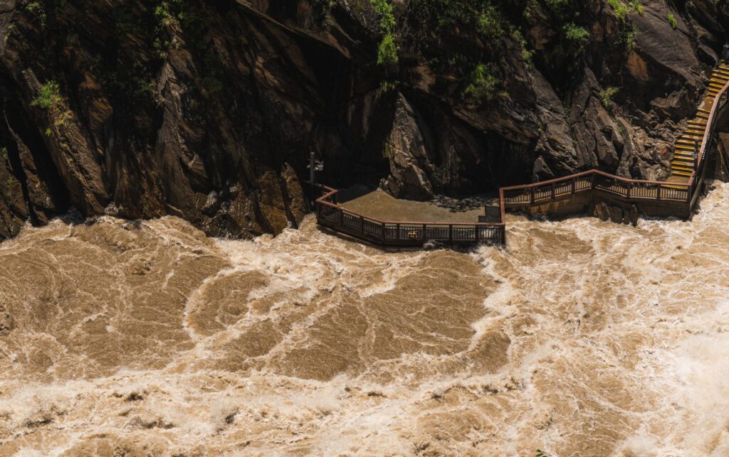 Powerful river rapids coursing through a rocky gorge with observation deck.