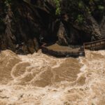 Powerful river rapids coursing through a rocky gorge with observation deck.
