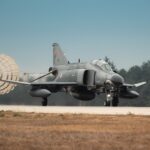 Turkish Air Force jet fighter landing with parachute deployed on runway in Türkiye.
