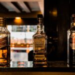 Close-up of whiskey bottles on a bar counter, creating a cozy ambiance in Pokhara, Nepal.