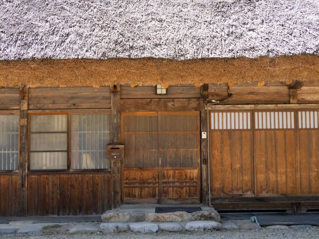 Explore the rustic charm of a traditional thatched-roof house in Shirakawa-go, Japan.