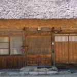 Explore the rustic charm of a traditional thatched-roof house in Shirakawa-go, Japan.