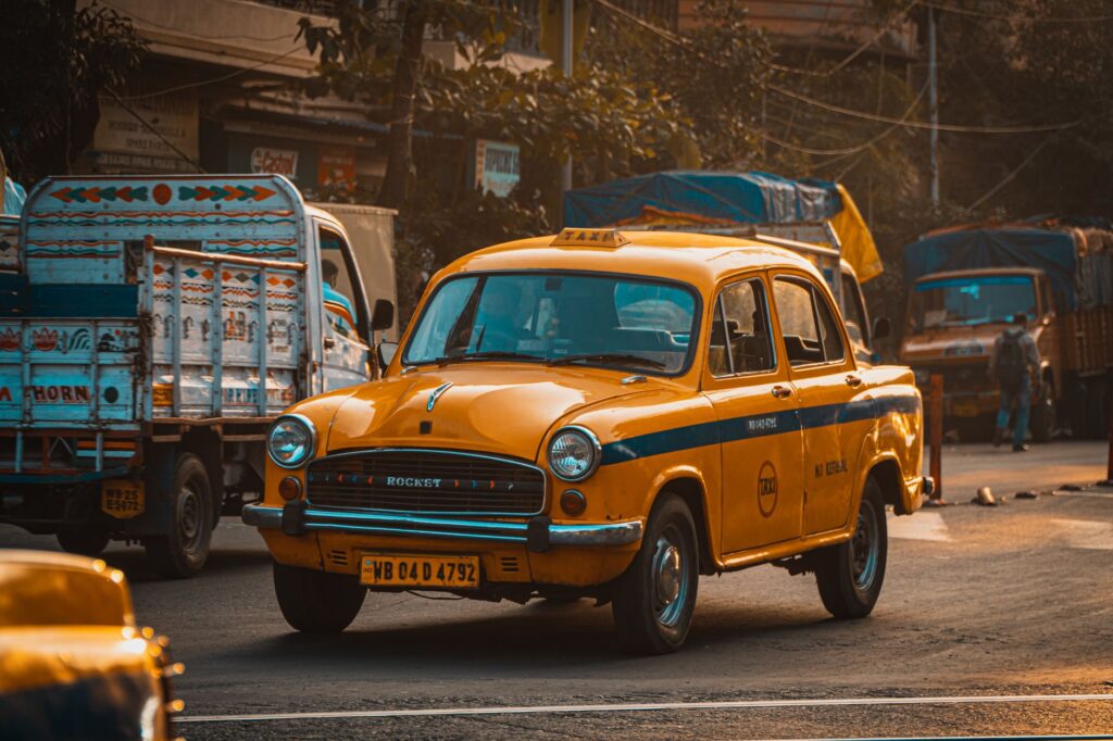 Classic yellow taxi in Kolkata, India, showcasing bustling city life and vintage charm.