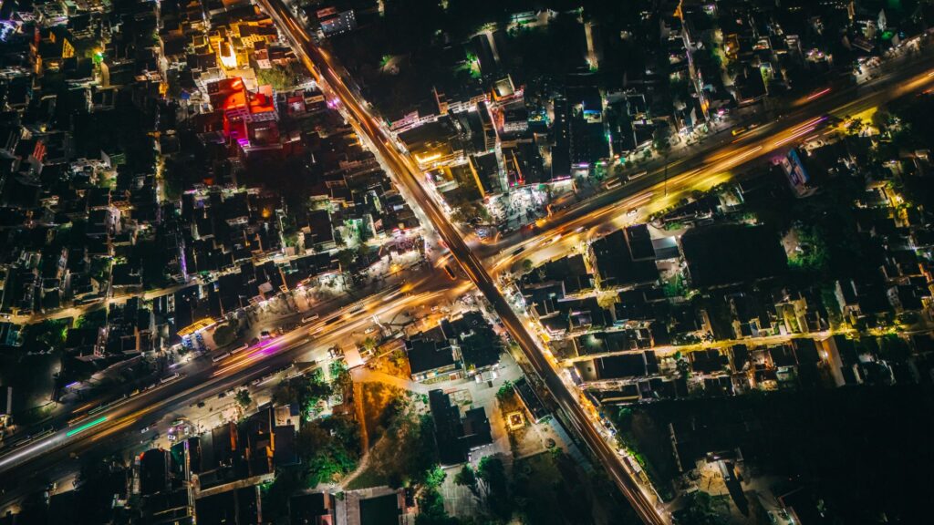 Vibrant aerial night view of Muzaffarpur, Bihar with illuminated streets and buildings.