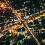 Vibrant aerial night view of Muzaffarpur, Bihar with illuminated streets and buildings.