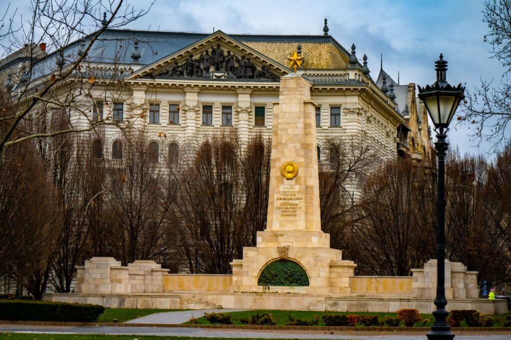 Soviet War Memorial in Budapest with a vintage building backdrop, captured during winter.