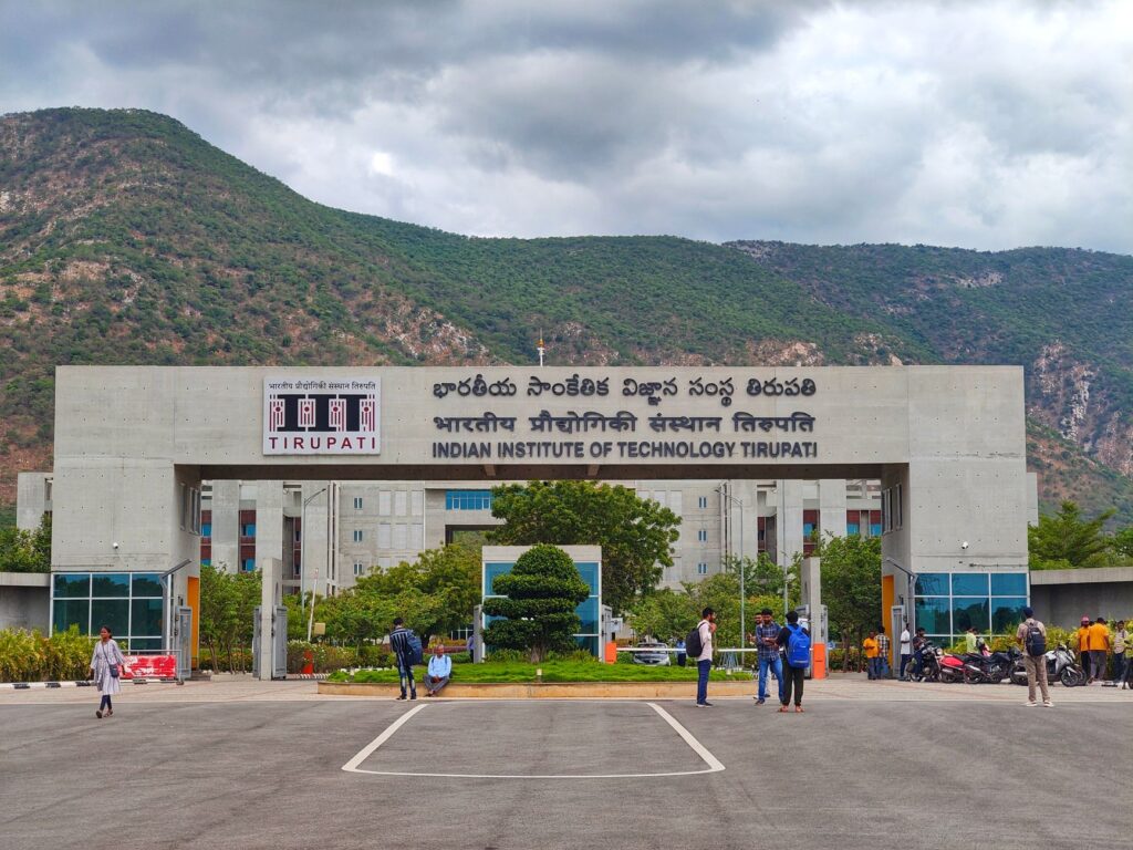 Main entrance of Indian Institute of Technology Tirupati with scenic mountains in background.