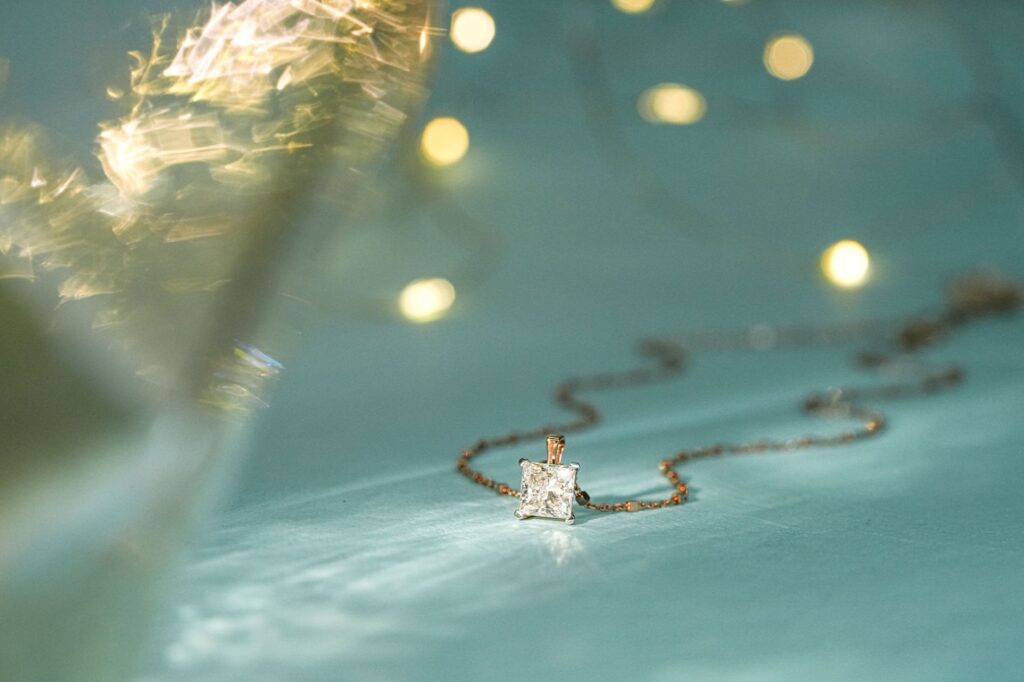 Close-up of a sparkling diamond pendant on a delicate chain, perfect for festive occasions.
