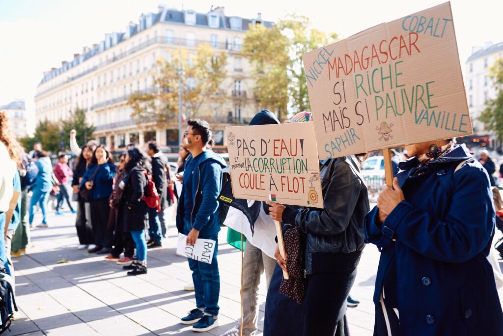Crowd gathering for a peaceful protest in Paris, raising awareness about Madagascar's political issues.