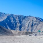 Breathtaking view of Leh's mountain range with unique formations and vibrant blue sky, perfect for travel inspiration.