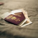 A close-up of a Polish passport and travel documents placed on a fabric surface, symbolizing travel and identity.
