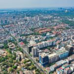 Vibrant aerial view of Yangon showcasing the urban skyline, lush greenery, and golden pagodas.