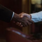 Close-up of a diverse handshake, representing business collaboration and diversity.