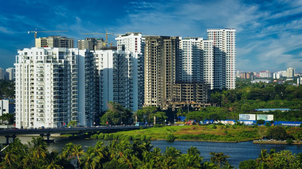 Stunning cityscape of Kochi's modern skyline with high-rise apartments and lush greenery.