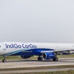 Side view of an IndiGo Cargo airplane on an airport runway during daytime.