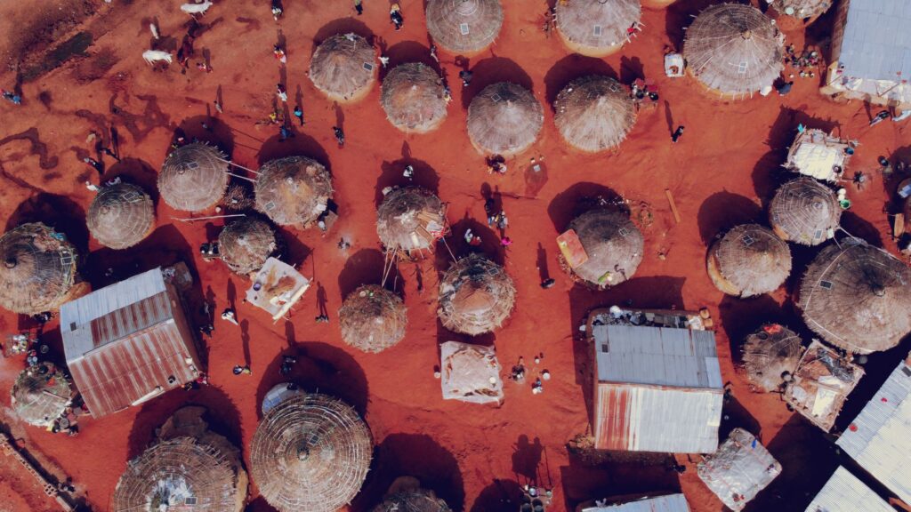 Drone shot showcasing traditional African huts in Abuja, Nigeria.