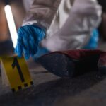 Crime scene investigation with shoe as evidence marked with number one and forensic glove.