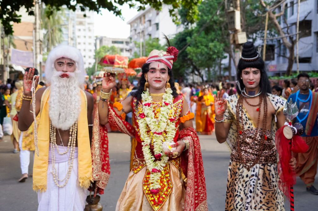 Vibrant celebration of a traditional Hindu festival in Dhaka with costumed participants and colorful decorations.