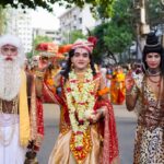 Vibrant celebration of a traditional Hindu festival in Dhaka with costumed participants and colorful decorations.