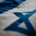 Detail of the Israeli national flag highlighting the Star of David, emphasizing its cultural significance.