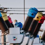 Colorful high voltage insulators in an electric substation highlighting power infrastructure.