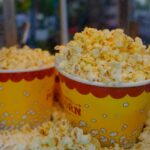 Delicious buttery popcorn in bright yellow buckets, perfect for movie night snacks.