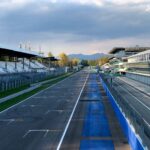 The empty pit straight at Monza Circuit in Italy, captured in serene afternoon light.