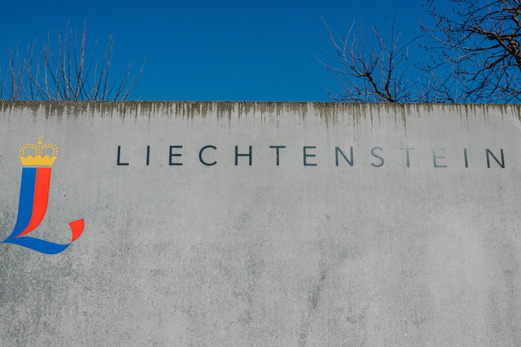 Liechtenstein sign on a concrete wall under clear skies in Lichtenstein, Germany.