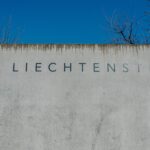 Liechtenstein sign on a concrete wall under clear skies in Lichtenstein, Germany.