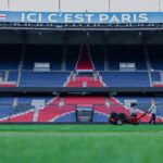 Gardener working on the field at Parc des Princes stadium, Paris. Vibrant and iconic sports venue.