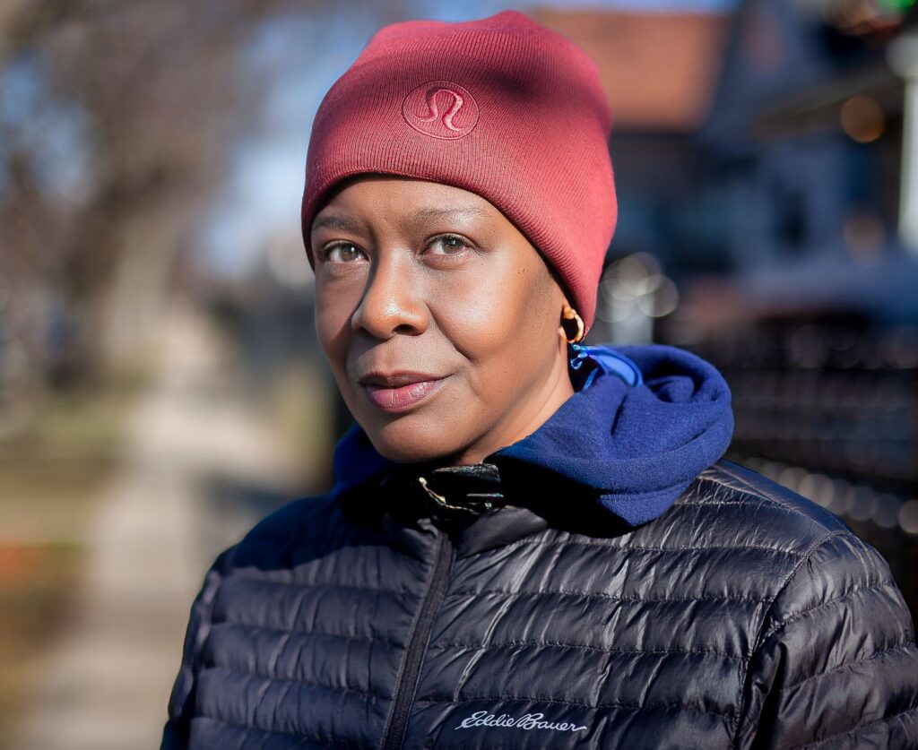 Stylish woman in winter attire, Chicago street scene, vibrant and expressive portrait.