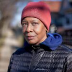 Stylish woman in winter attire, Chicago street scene, vibrant and expressive portrait.