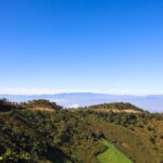 Beautiful view of lush mountains and blue sky in Churachandpur, India.