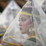 A Manipuri dancer adorned in traditional attire during a cultural performance in Imphal, India.