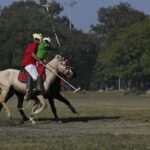 Captivating scene of a traditional polo match on a sunny day in Imphal, Manipur, India.