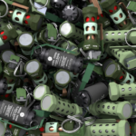 Close-up image of various military flash bang grenades with green and black casing.