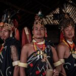 Three men in traditional tribal attire from Nagaland, India, embodying rich cultural heritage.