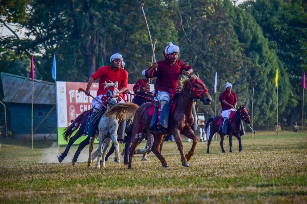 Dynamic image of a thrilling polo match with players on horseback in Imphal, India.