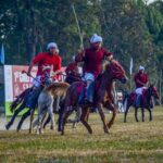 Dynamic image of a thrilling polo match with players on horseback in Imphal, India.