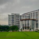 Modern architectural view of Daffodil International University with lush green surroundings in Dhaka.