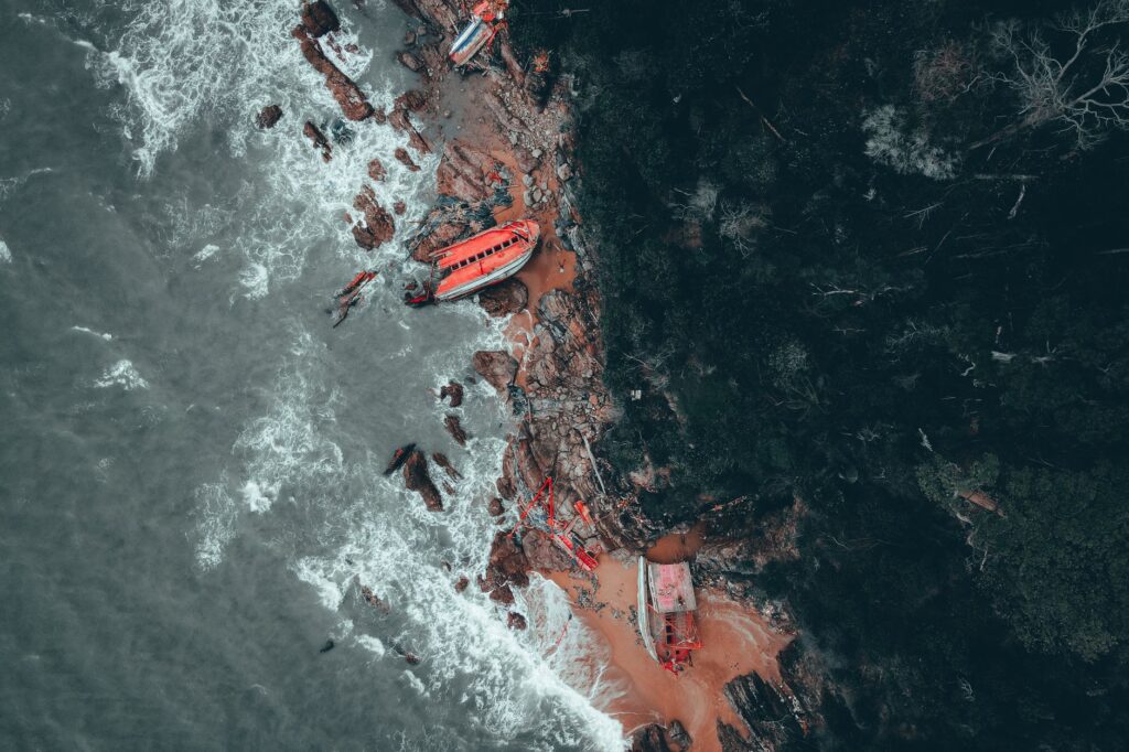 Dramatic aerial shot of a shipwreck on the rocky coast of Kemaman, Malaysia.