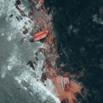 Dramatic aerial shot of a shipwreck on the rocky coast of Kemaman, Malaysia.