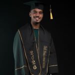 Portrait of a young male graduate smiling in cap and gown with class of 2026 inscription.